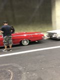 Red Coupe and a Man in Shorts