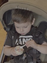 Toddler Enjoying Cupcake in Stroller