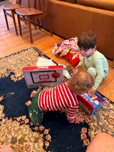 Children Opening Christmas Presents on Living Room Floor