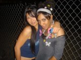 Two Women Smiling in Urban Tennis Outfits