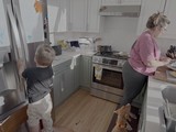 Mother and Child Cooking Together in Kitchen