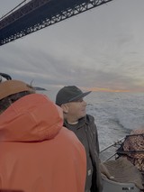 Maritime Workers Under Bridge at Sunset