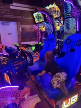 Gamer Playing Virtual Reality Motorcycle Arcade Game