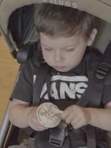Young Child Enjoying Snack in Stroller