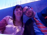 Couple Poses Together in Blue-Lit Lounge