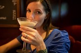 Woman Savoring a Cocktail at Upscale Bar
