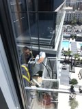 Working on a window in a busy metropolis