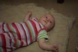 Curious Infant Gazing Upward on Knit Blanket