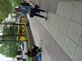 Street Musician and Passerby on Tbilisi Boulevard