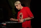 Red-Shirted Deejay Spinning the Time Away