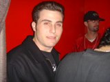 Stylish Man in Black Jacket and Baseball Cap