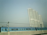 Train Traveling Through Urban High Rises