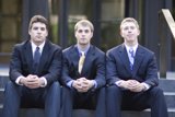 Three Men in Suits Take a Group Shot on Stairs