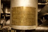Golden Plaque on Industrial Pipe