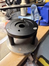 Black Anodized CNC Machined Component on Workshop Table