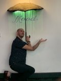 The contemplative man with the green umbrella