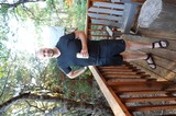 Man Relaxing on Lakeside Cabin Deck