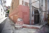 The Brick Building and Chain Link Fence in the City