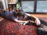 Woman Bonding with Dog on Living Room Floor
