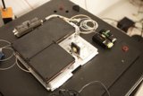 Small Electronic Device with Wires and Other Electronics on a Table