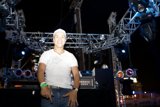 Man in White Shirt Stands Center Stage