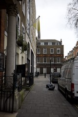 Narrow London Alley Leading to Historic House of Charity