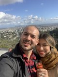 Happy couple captures city skyline in selfie