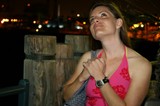 Woman Gazing Upward at Waterfront Night Scene