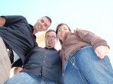 Three Friends Grinning Down at a Worm's-Eye Camera