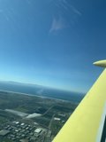 A Bird's Eye View Caption: Enjoying the azure sky and stunning cityscape from the wing of a small airplane in 2018.