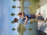 Couple Playfully Embracing by Desert Waterway