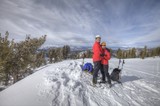 Couple Embracing on Snowy Mountain Summit at Lake Tahoe
