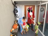 Family Halloween Trick-or-Treating at the Front Door