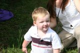 Little Boy Standing on a Green Lawn