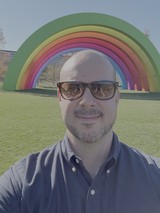 Man Takes Selfie at Colorful Rainbow Art Installation