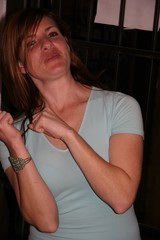 Woman in Light Blue Tee Poses Playfully Indoors