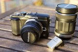 Camera and Lens on Wooden Table