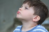 Young Boy Looking Upward in Contemplative Profile Portrait
