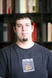 Man in Black T-Shirt Checking Out a Bookshelf