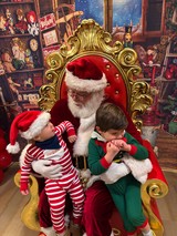 Two Children Visit Santa in His Workshop