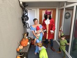 Family Peter Pan Halloween Costume Portrait on Decorated Porch
