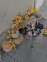 Child's Joyful Autumn Day with Fall Decorations