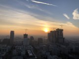 Urban Sunset with Construction Cranes