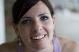 Freckled Woman with Blue Eyes Smiling Warmly