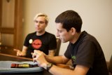 Two Men Discussing with a Tennis Ball on the Table