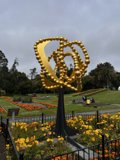 Golden Park Statue with Blooming Beauty