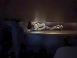 Child Resting Peacefully on Living Room Couch