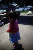 Little girl enjoys flying kite on a sunny day