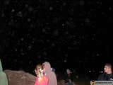 Nighttime Snowfall on Rocky Terrain