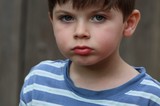 Young Boy in Blue Striped Shirt - Close Portrait